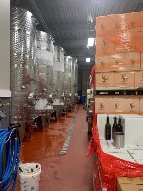 A row of metal wine aging canisters